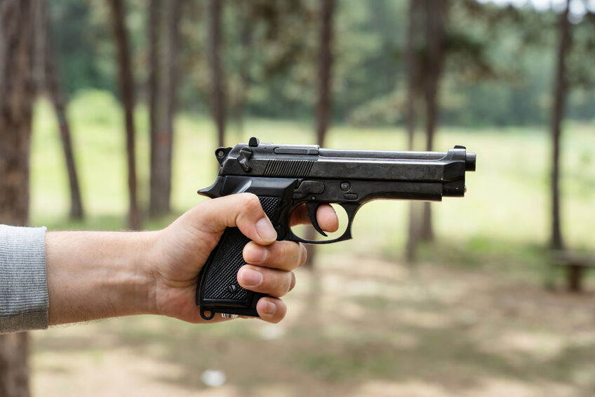 sideview of someone holding gun