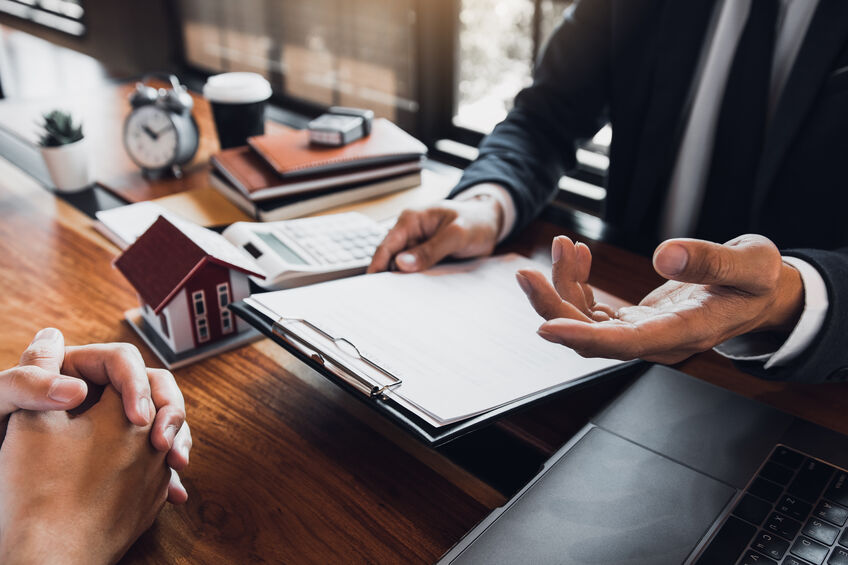 insurance agent handing document to client