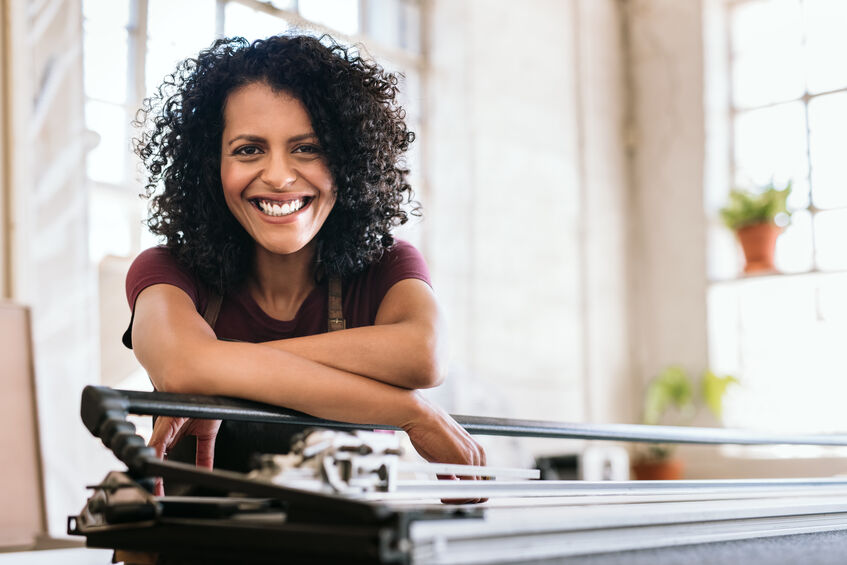 smiling young woman leaning against printer