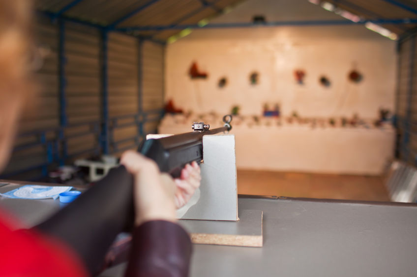 Woman shoots a gun at a shooting range.