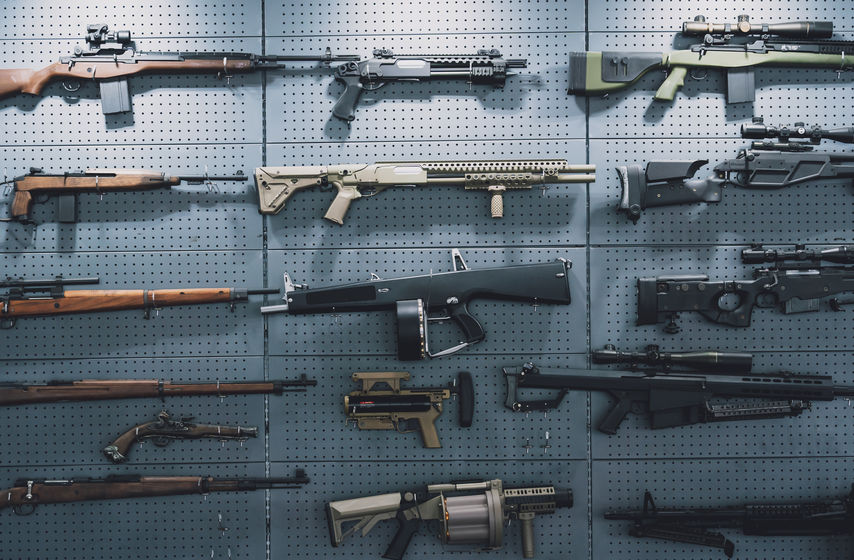 Collection of rifles and carbines on the wall.
