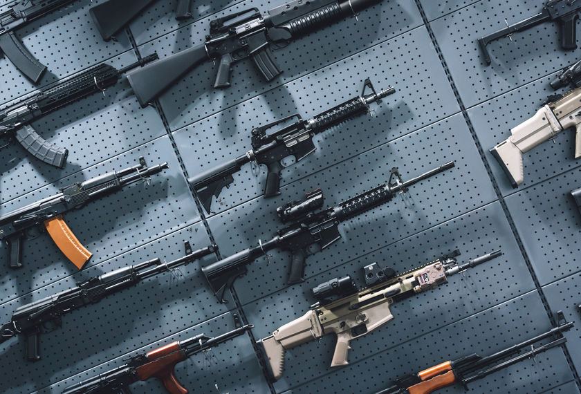 Collection of rifles and carbines on the wall.